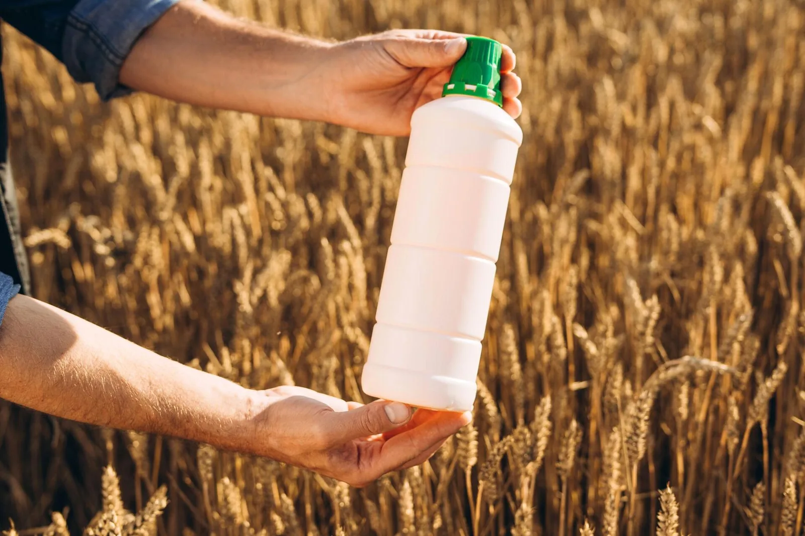Agrochemical HDPE bottles moving through inline bottle inspection system