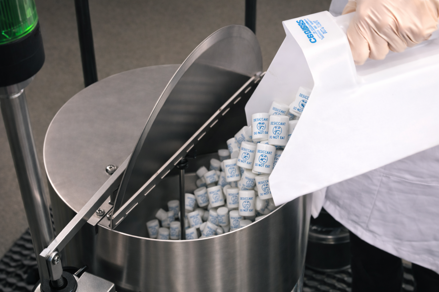 Desiccant canister being placed into a pharmaceutical bottle