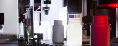 Single-camera view inside Optomech BIS inspection system showing bottle in inspection zone